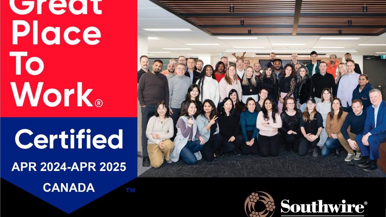A group posed in a room. "Great Place to Work Certified" badge on the left.