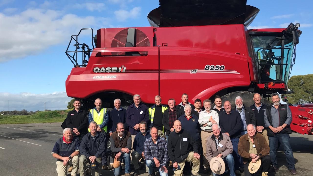 Group in front of red tractor