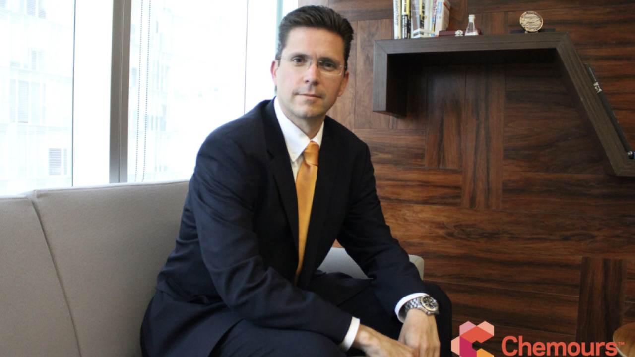 Gerardo Familiar seated in a casual setting, a wood bookcase behind him. Chemours logo in the right corner.
