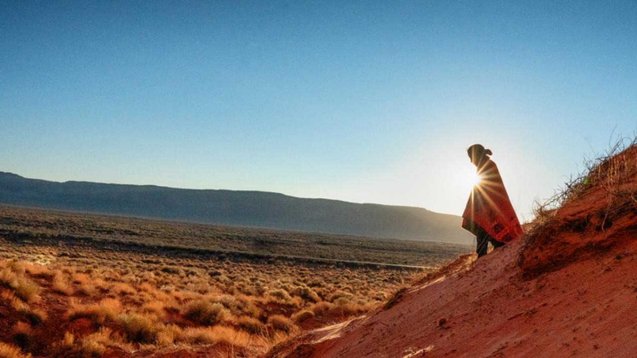 person on mountain at sunrise