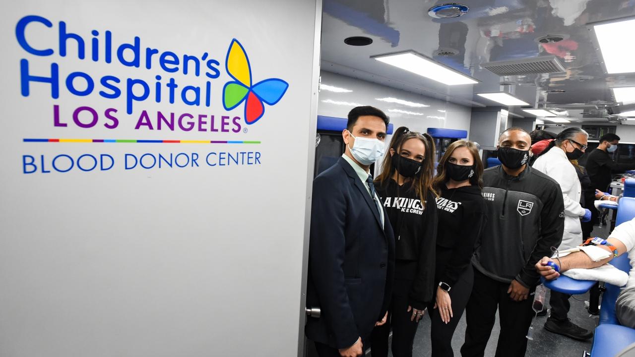 Group standing near sign reading, "Children's Hospital Los Angeles Blood Donation Center"