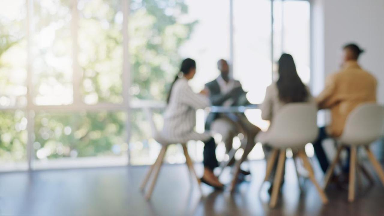 Coworkers meeting around a table