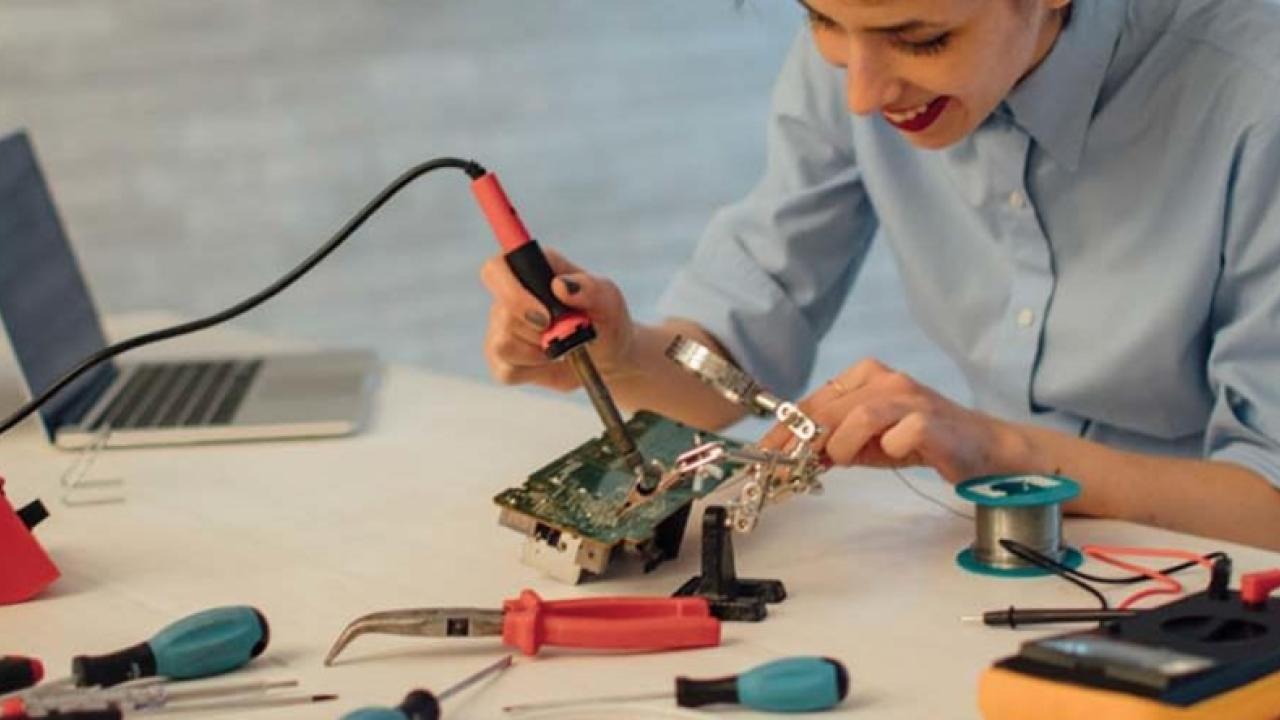 Student working with laptop and tools