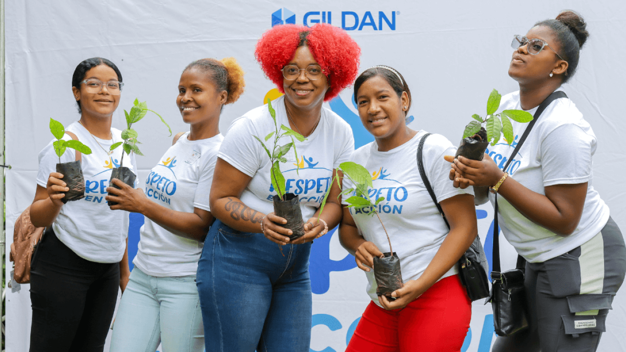 Five employees at a Gildan reforestation event