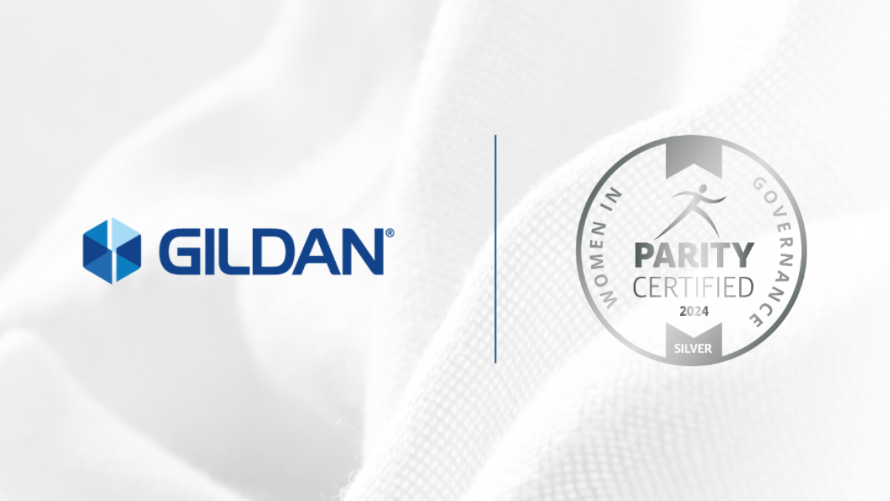 Gildan logo and Women in Governance Silver Level Parity Certified Logo against a white fabric backdrop