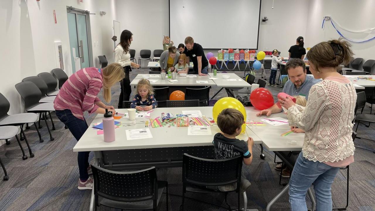 adults and children participating in science experiments and activities