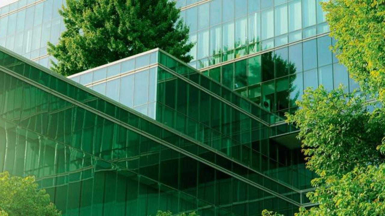 A glass building surrounded by trees