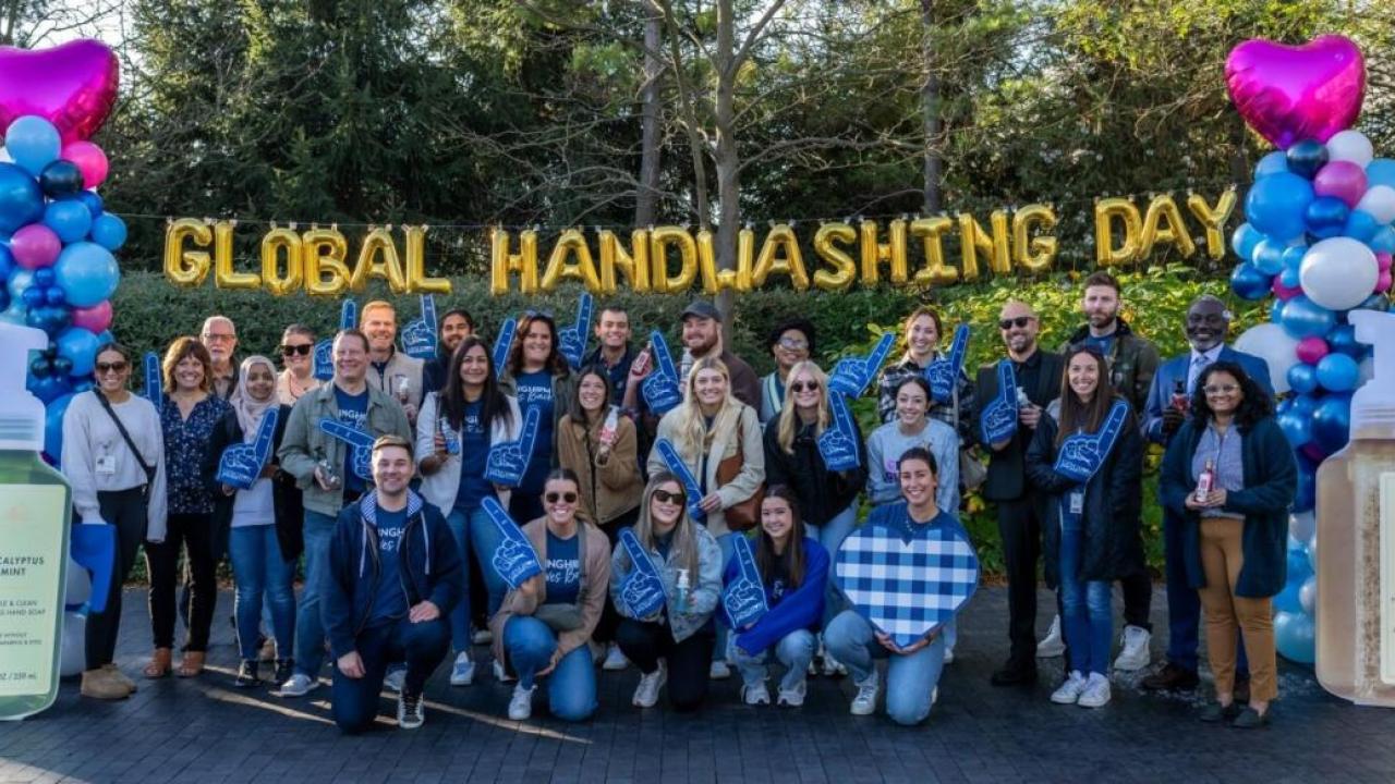 Group in front of Global Handwashing Day letter balloons