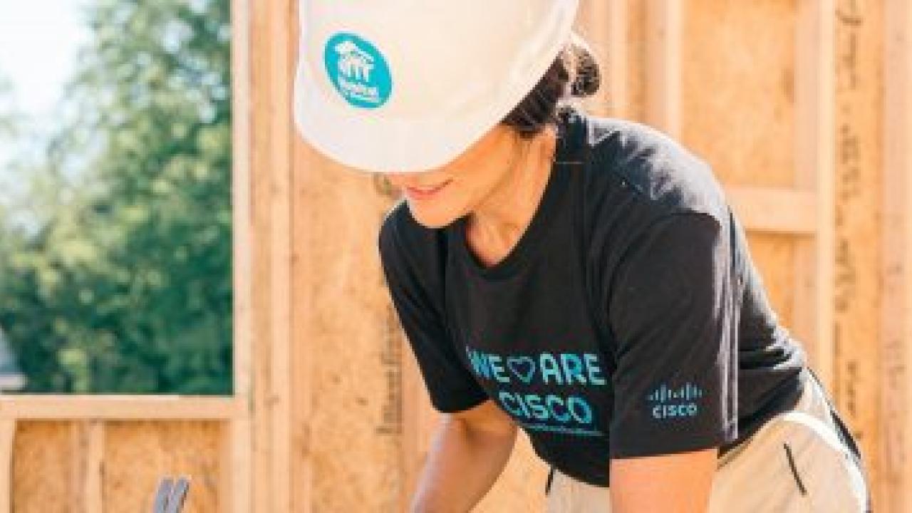 person wearing a hard hat building a structure