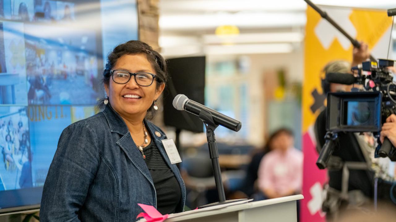 Cherilyn Yazzie standing at a podium