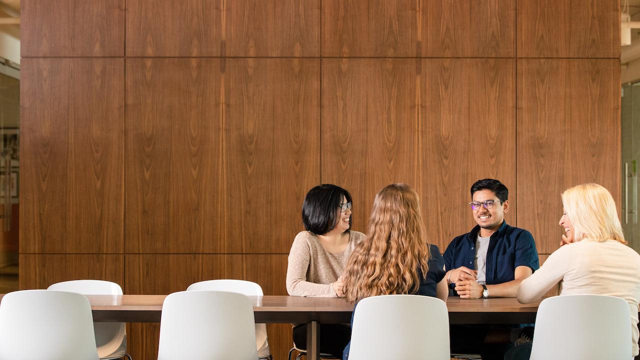 Four people sitting at a table.