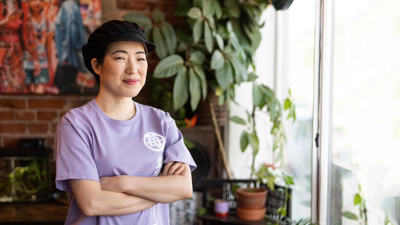 Mia Oi with arms crossed.