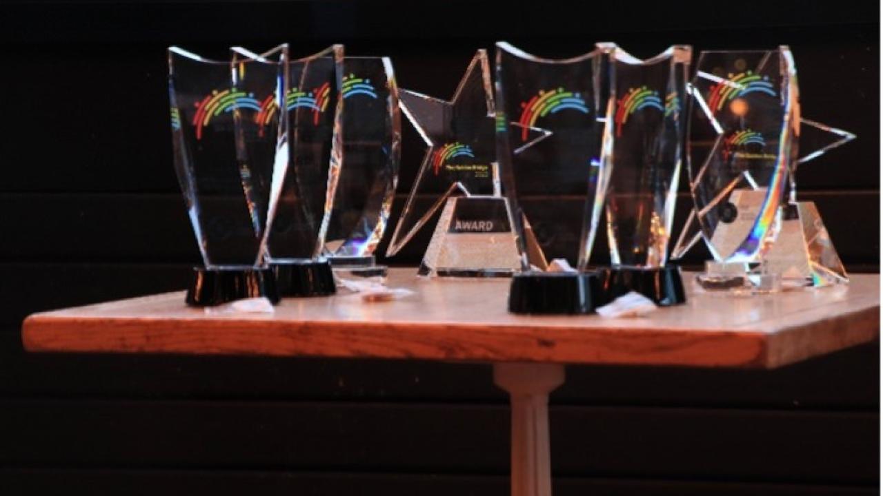 Golden Bridge Award trophies on a small table