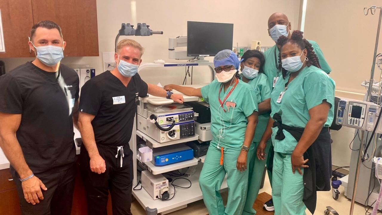 Healthcare workers standing by medical equipment