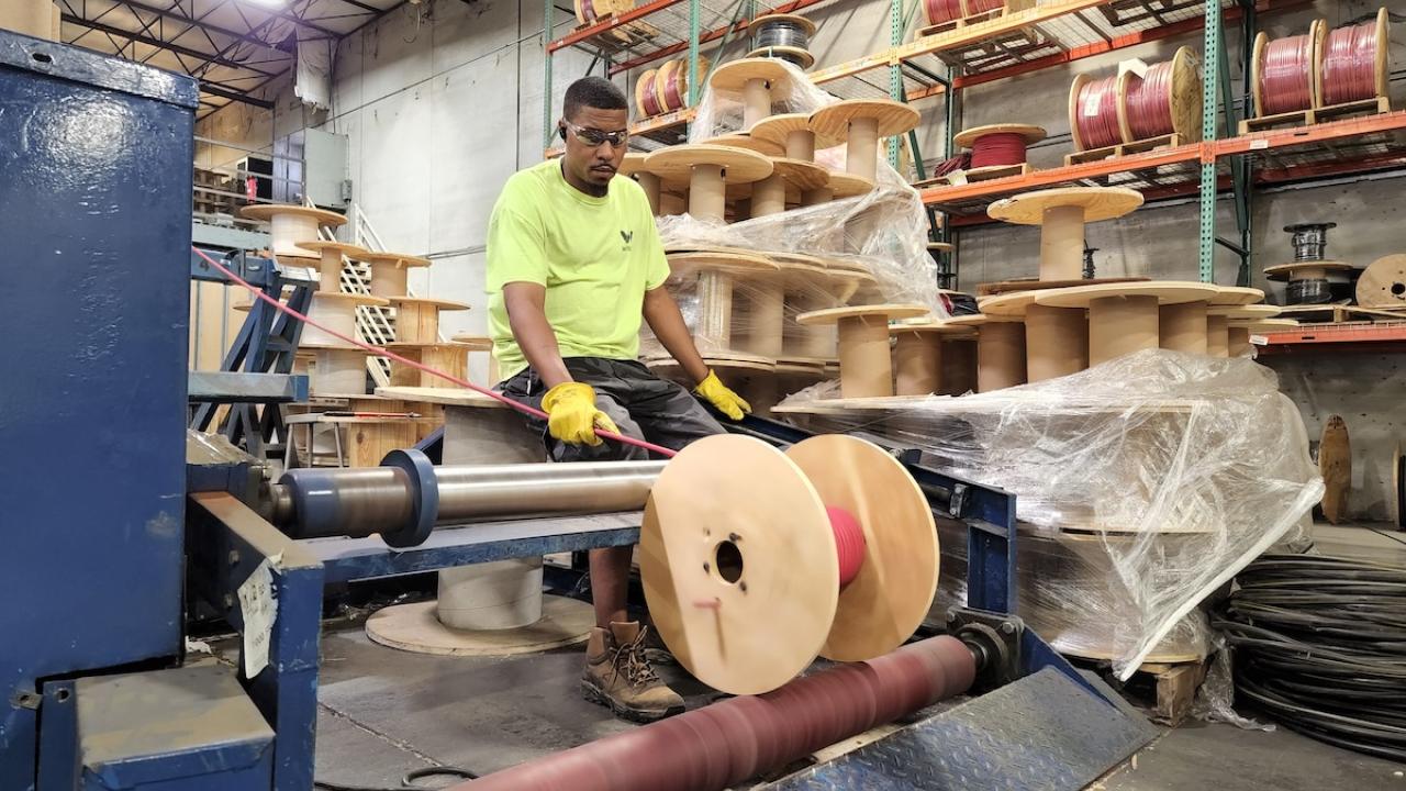 Wesco employee cutting wire.