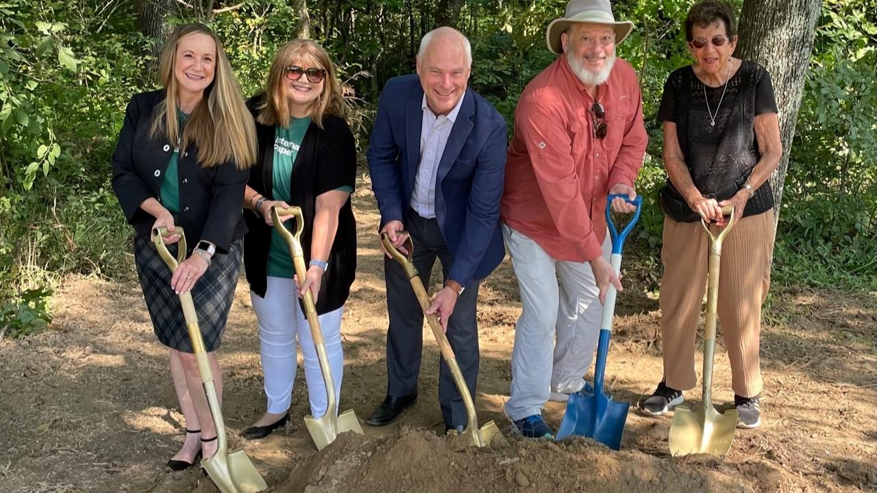 People posing with shovels at the Lichterman Nature Center