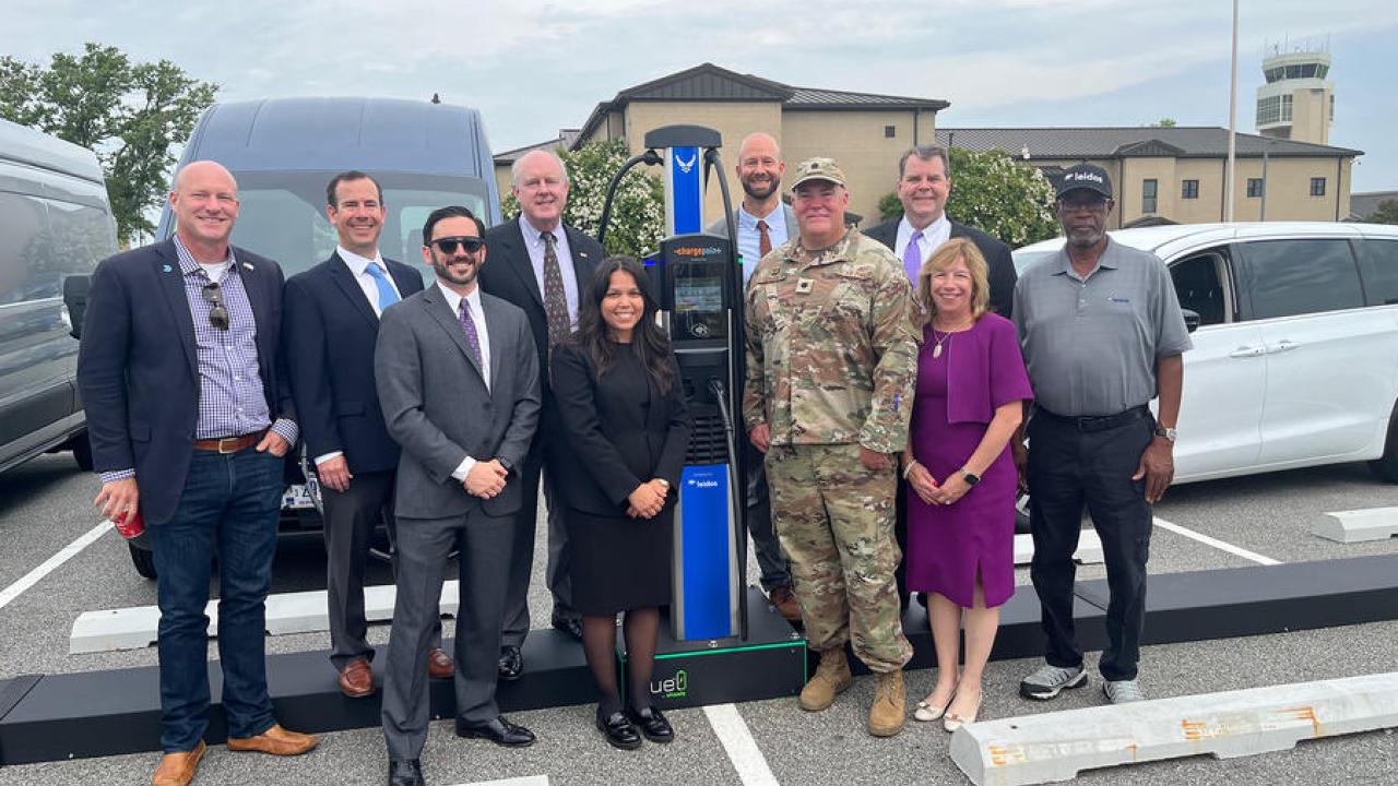 Leaders from Leidos, the Defense Innovation Unit, and the Office of the Deputy Assistant Secretary of the Air Force for Environment, Safety, and Infrastructure celebrate the official EV Charging as a Service ribbon cutting at Dover AFB. Photo: Airman Liberty Matthews