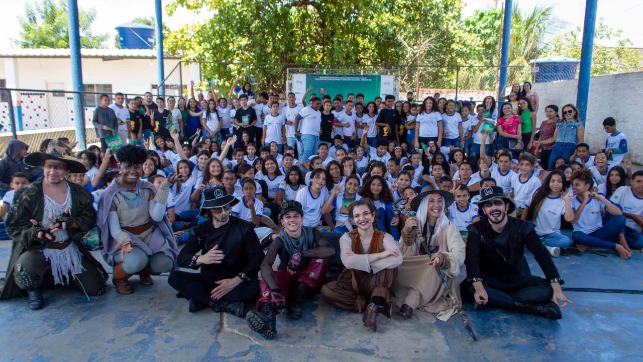 A seated group posed. Some in costumes in front.