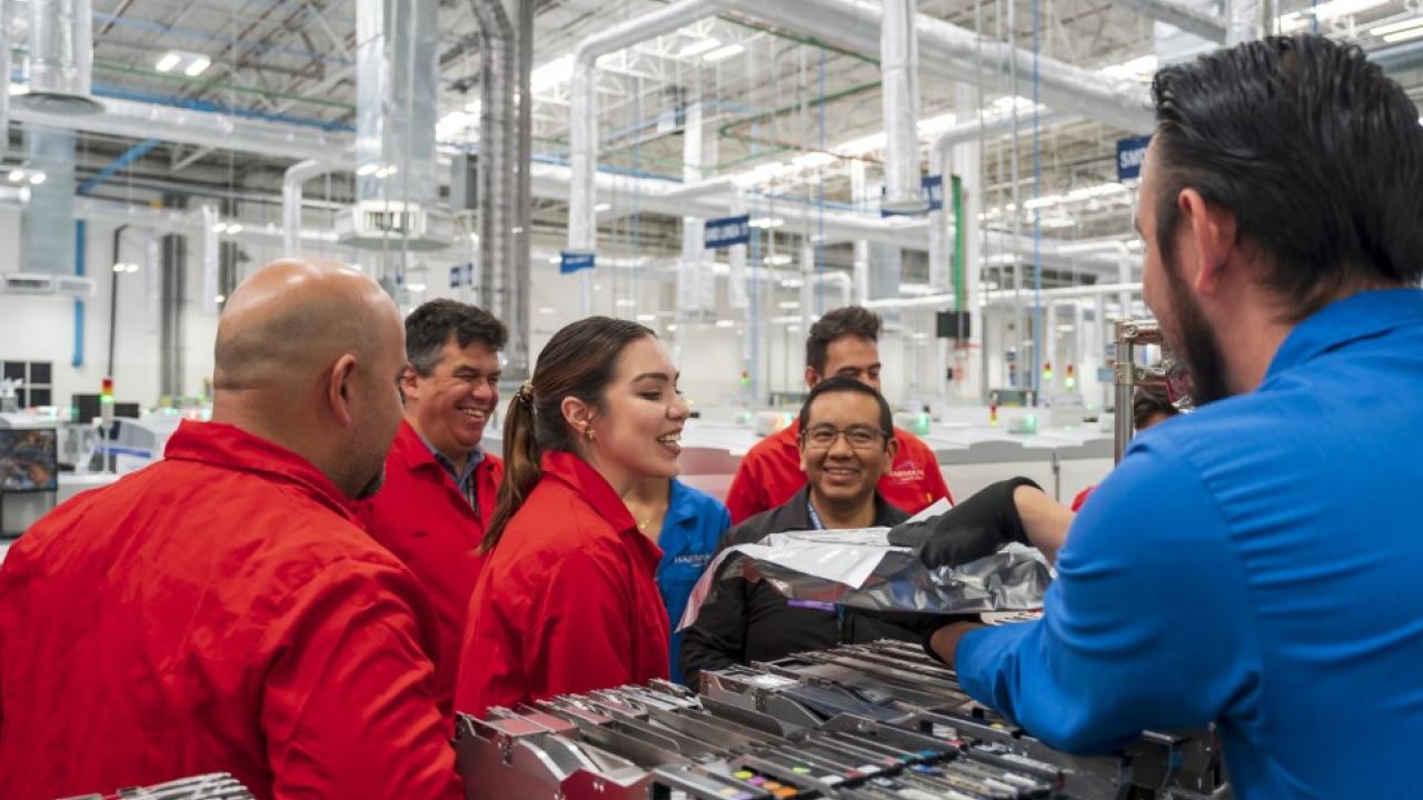 HARMAN team members shown in a factory.