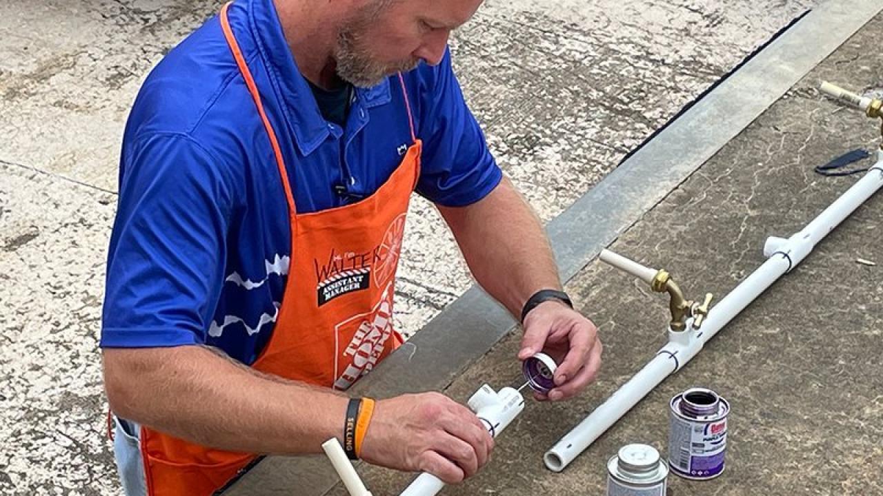 Home Depot volunteer installing the fresh water supply.