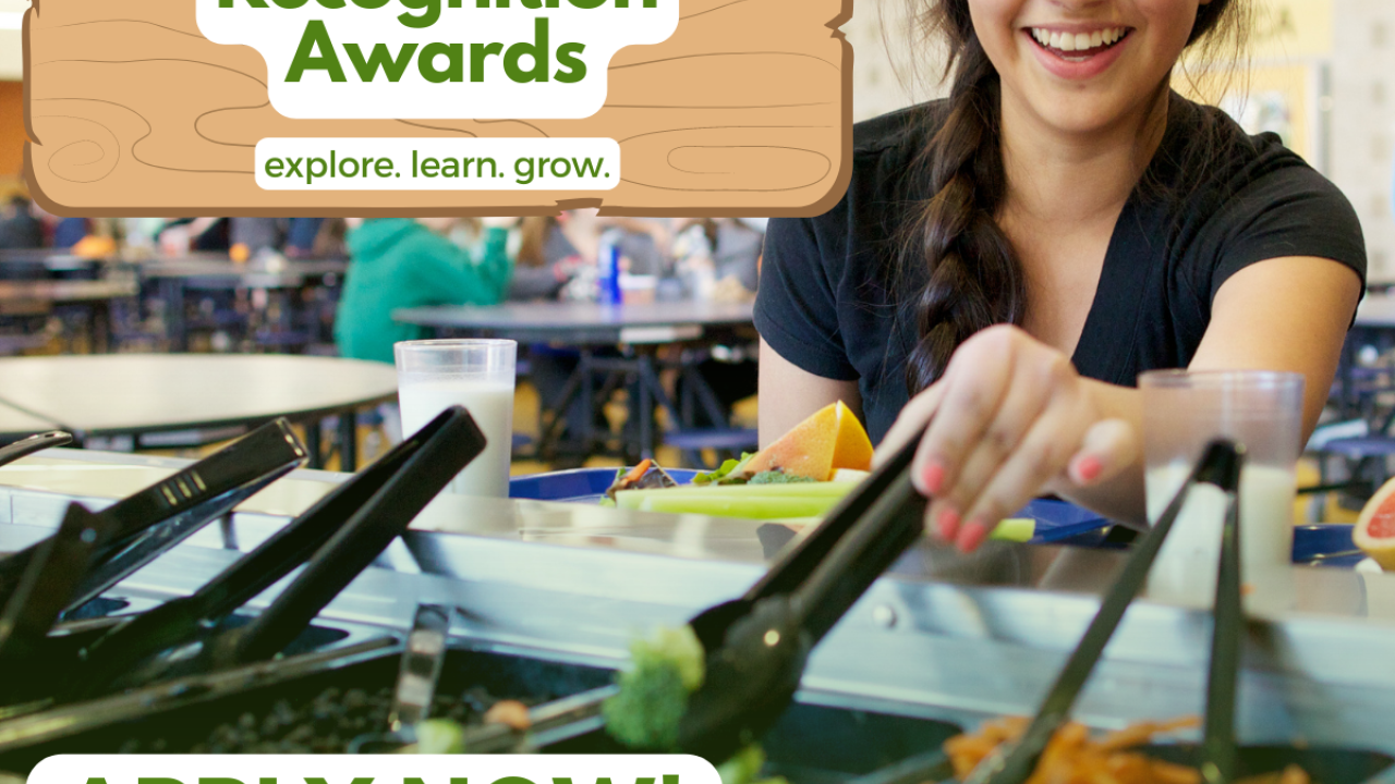 Girl getting food from cafeteria salad bar