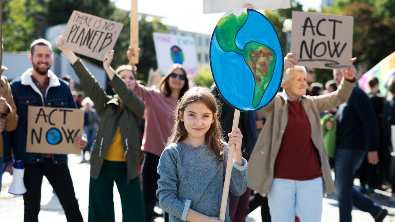 People holding signs for climate change at a protest