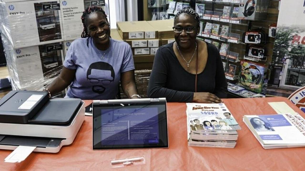 Tanesha Grant (left), founder of the digital equity nonprofit Parents Supporting Parents NYC, and PSPNY Senior Advisor Elzora Cleveland at a recent technology giveaway event at the PC Richard & Son Harlem Superstore in New York.