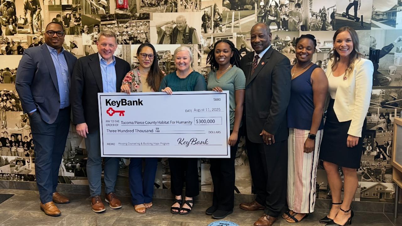 Representatives from KeyBank and Habitat for Humanity shown with a $300,000 grant check.
