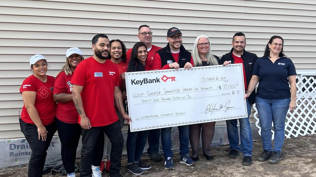 Photo: (from left) KeyBank branch employees Janis Deynes, Sharia Coley, Josh Flores, Norbert Grant III, Priya Tater, Tom Morace, Jeff Guyott,  Kendle Taylor, and Holyoke Branch Manager Tito Ramon who presented the grant check to Habitat for Humanity’s Executive Director Aimee Giroux (far left). 