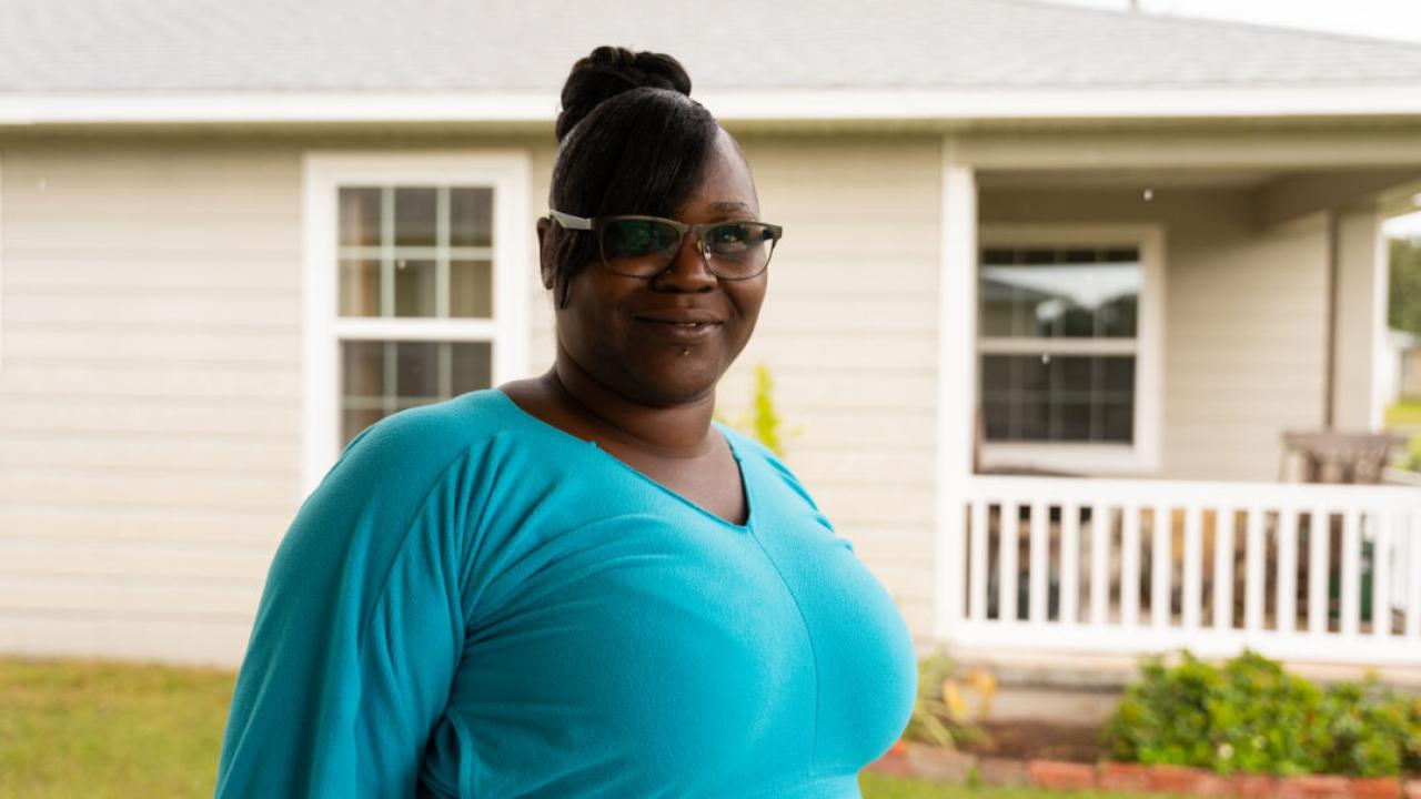 Melissa shown in front of her new home.