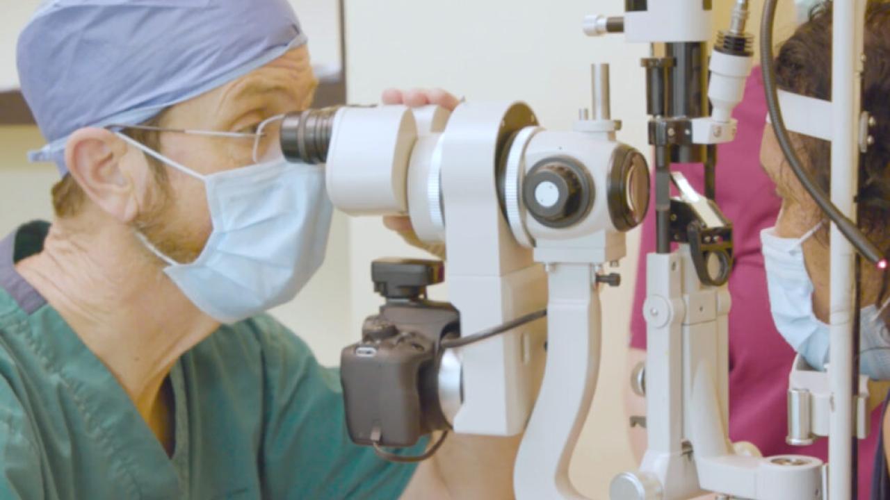 Opthalmologist looking through a microscope.