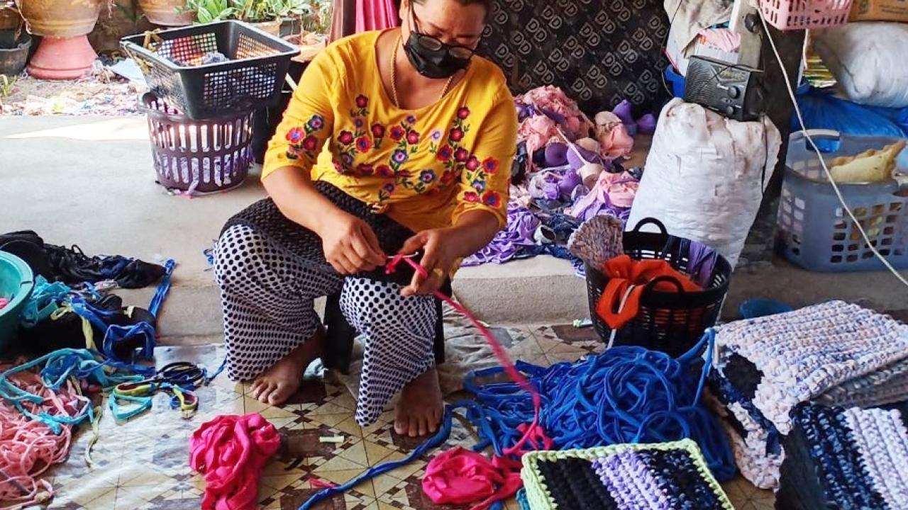 Thai woman weaving yarn.