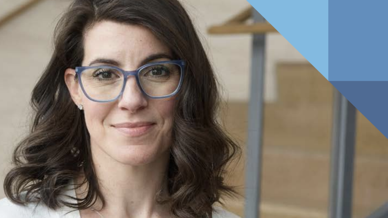 Headshot of a person wearing glasses