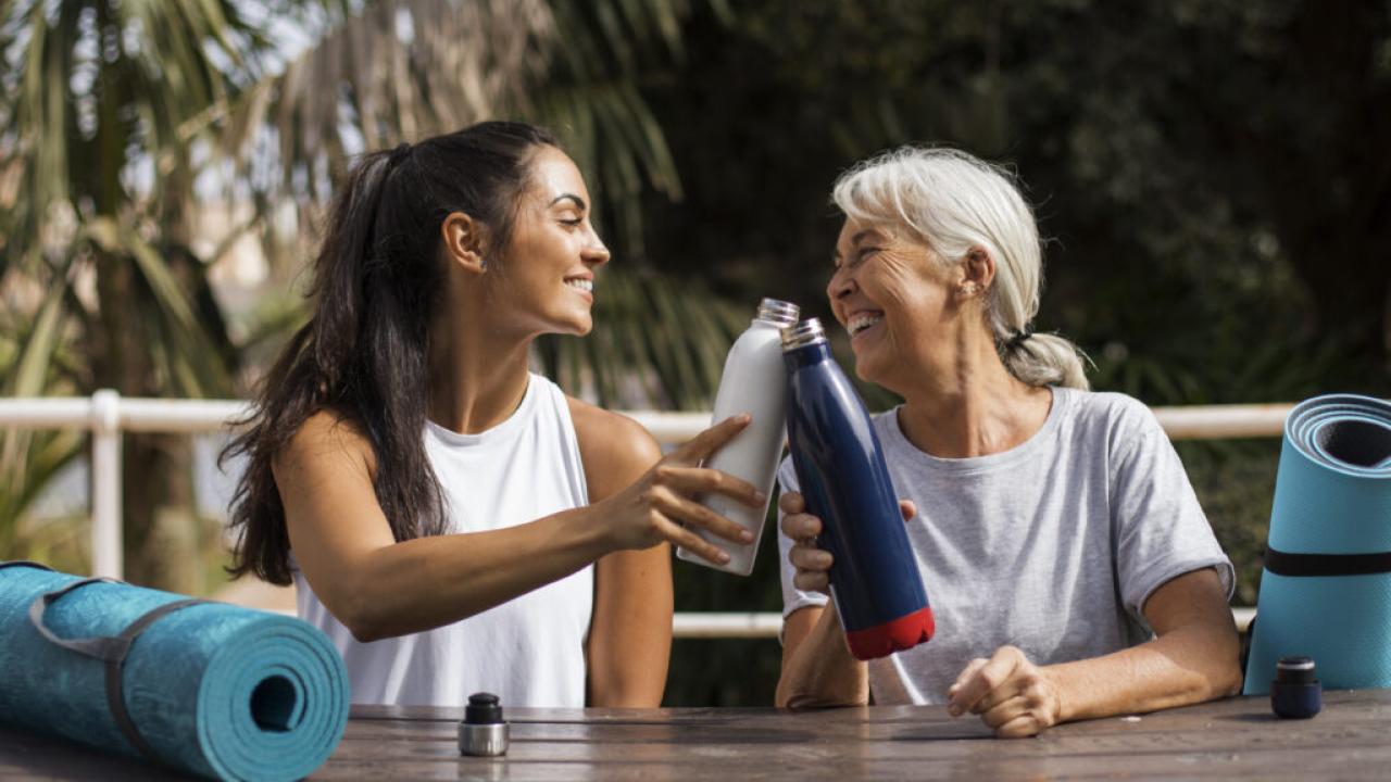Two women drinking water after yoga.