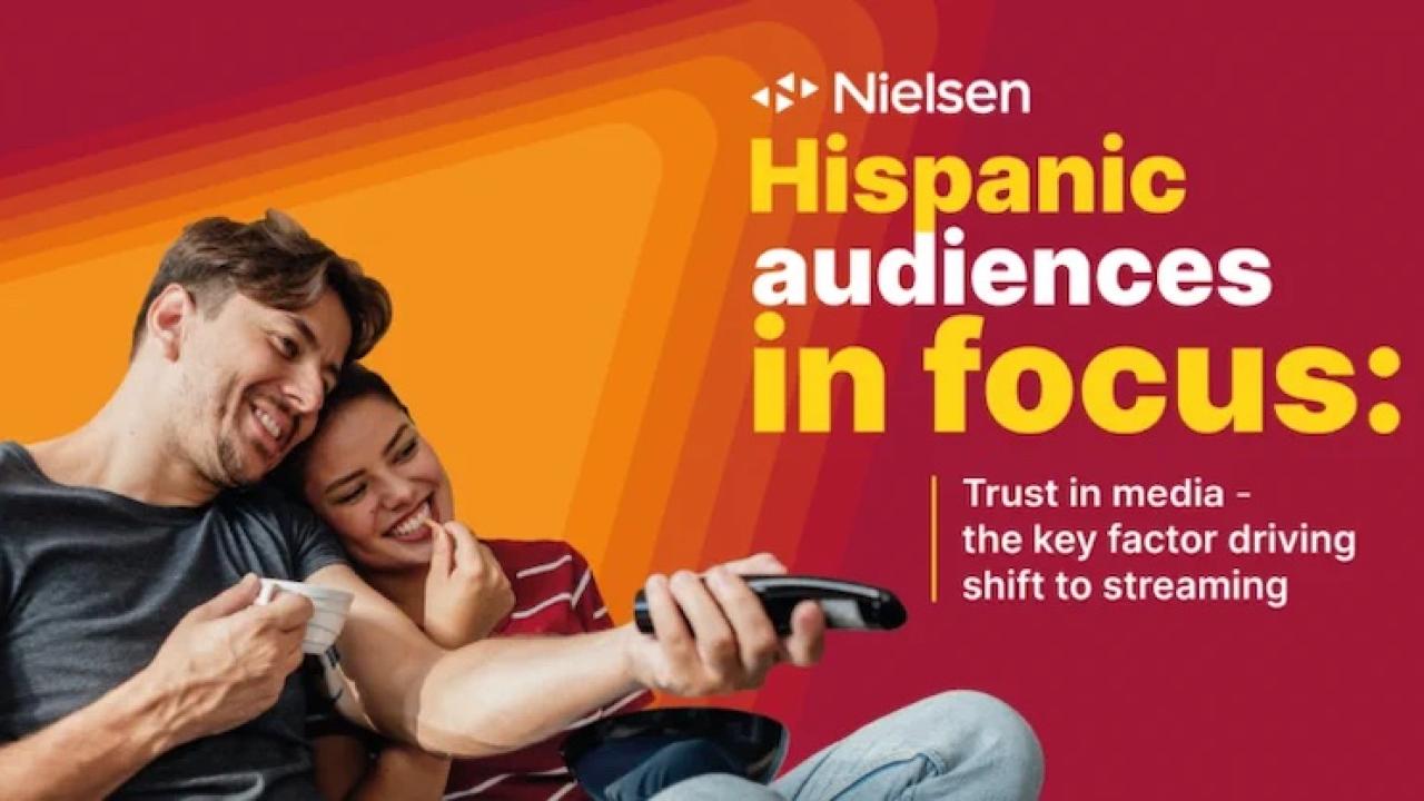 Nielsen Hispanic audiences in focus. Trust in media. Couple shown with a remote control.