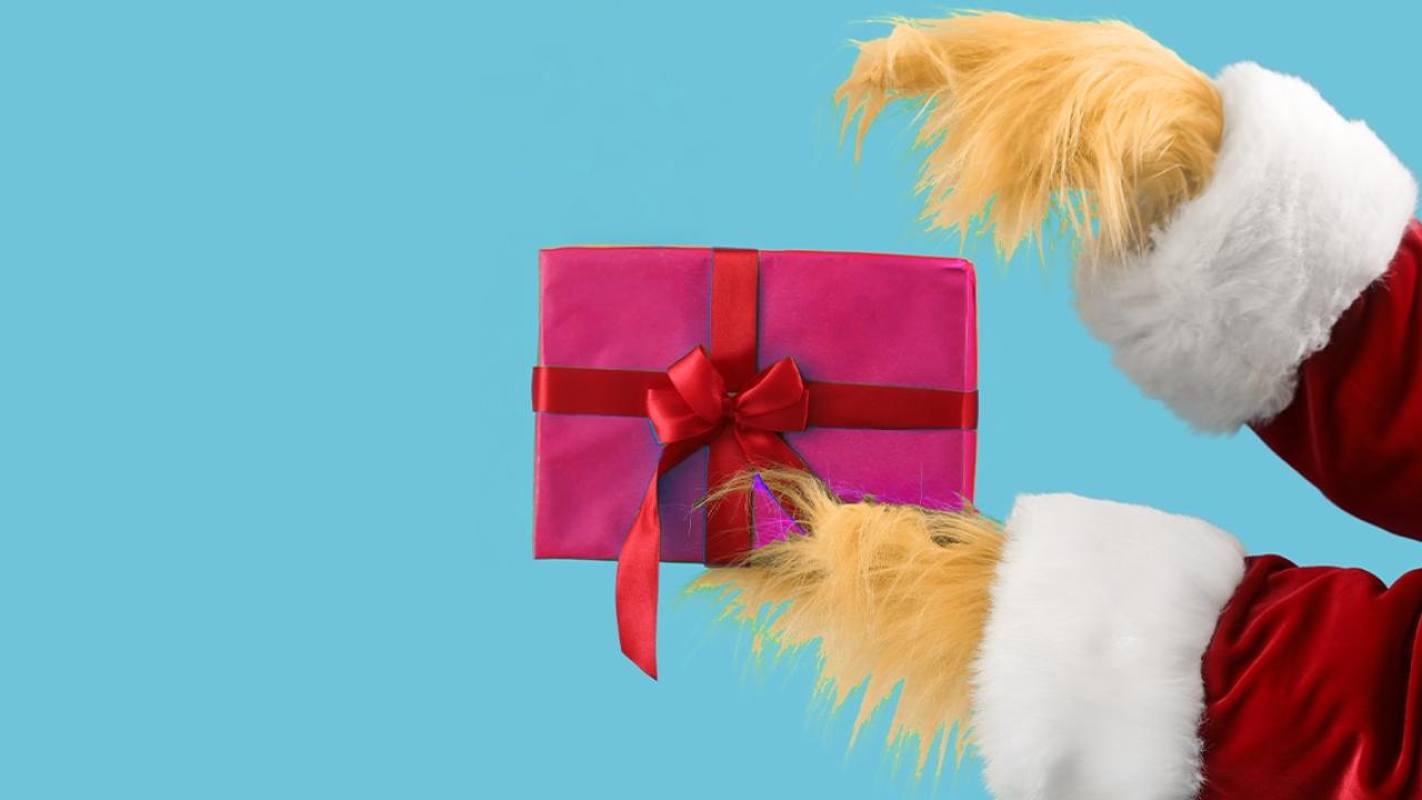 Grinch hands holding a gift