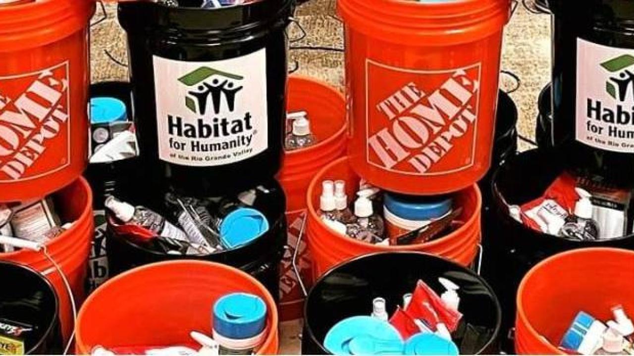 Stacked containers labelled with Home Depot and Habitat for Humanity.
