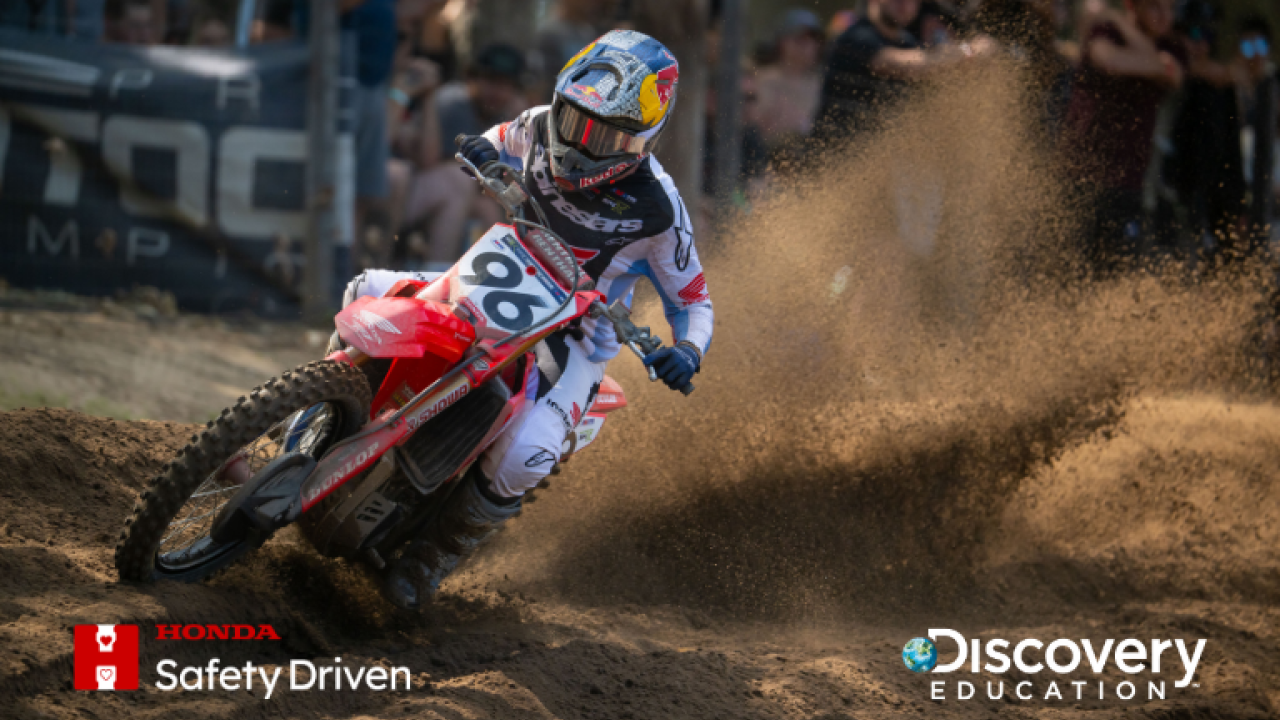 Red motorcycle driving down track