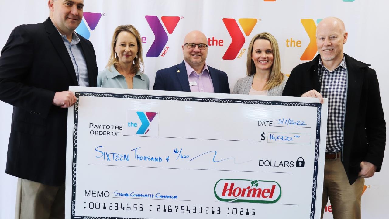 check presentation with five people standing behind check