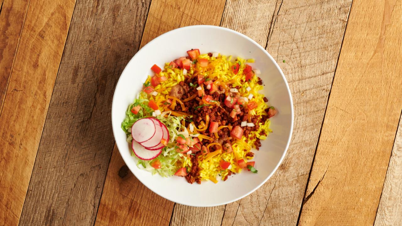 Vegan chorizo bowl on a wooden table
