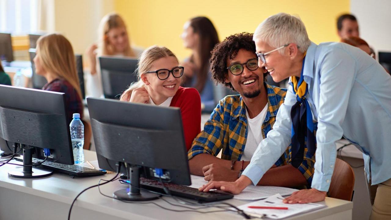 People gathered around a computer