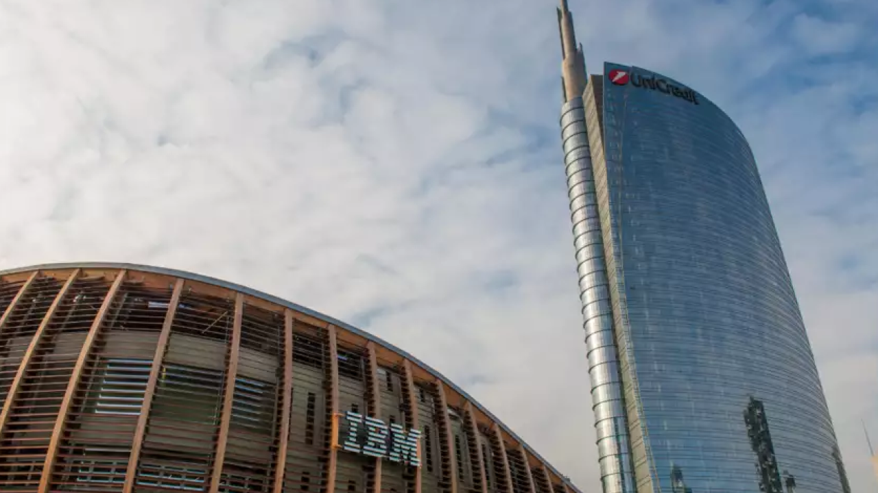 Exterior of a building with "IBM" on the side. A tall skyscraper behind it.