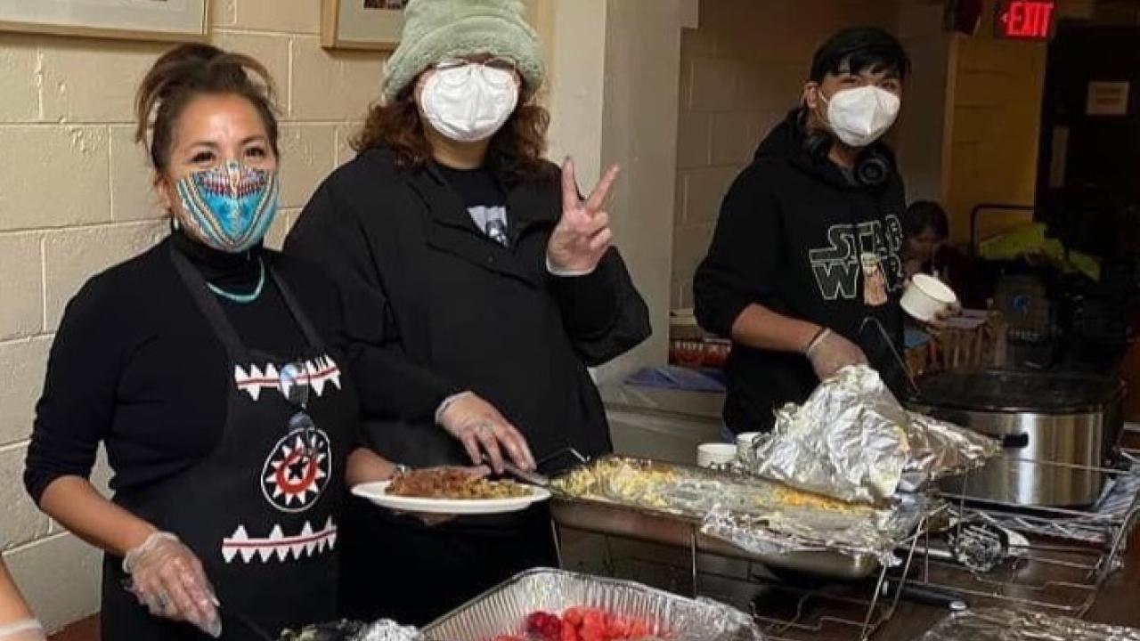 group of people wearing masks and smiling