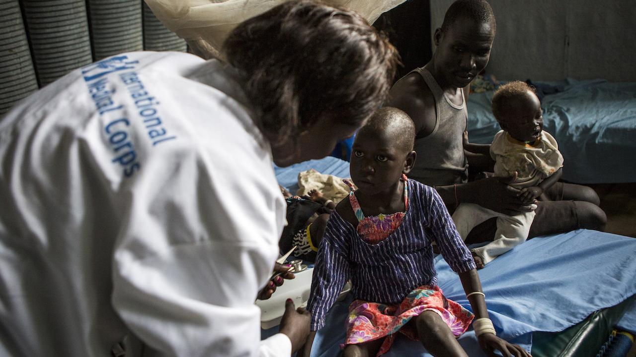 a doctor helps a young child