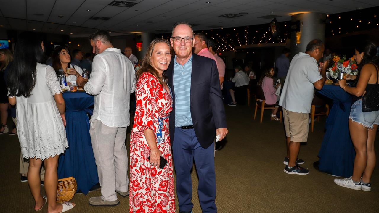 Two people at Homeruns & Highballs fundraiser