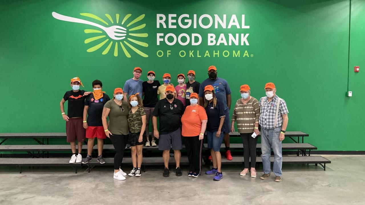 Oklahoma City employees take a timeout from preparing boxes of food and meals at the Regional Food Bank of Oklahoma on Sept. 17, 2022.
