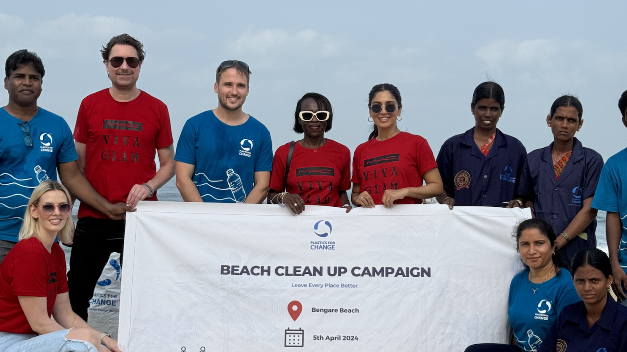 Volunteers pose with Beach clean up campaign banner