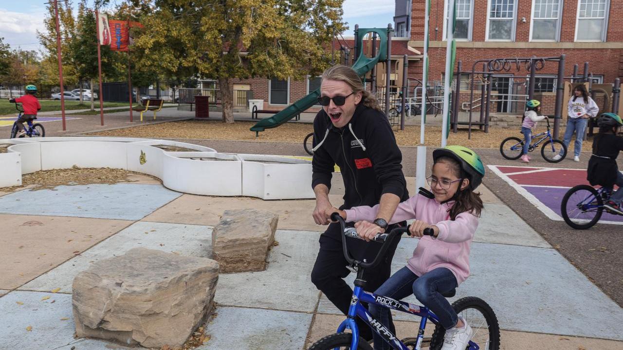 AEG employees helped teach the students how to ride a bike. (Photo: Jon Angel)