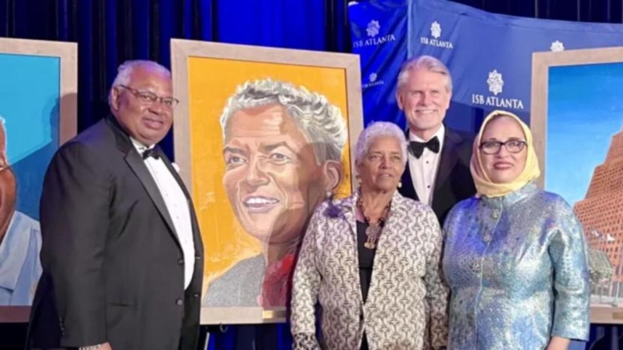 People stood near artwork at the annual ISB Celebrating Diversity & Inclusion Gala