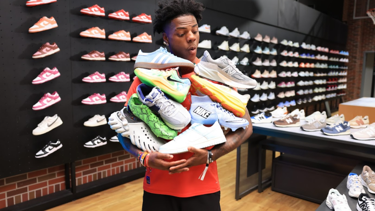 IShow Speed shown with an armful of sneakers.